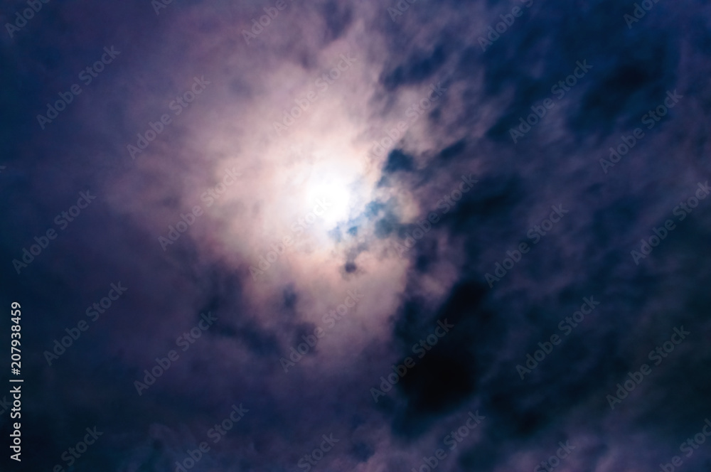 Obraz premium Beautiful, unusual sky. Blue clouds.The sun is behind the clouds.