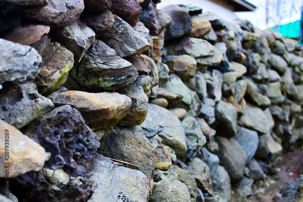 Fototapeta premium The Walls made by Stones to avoid heavy wind from the Sea are the keynote of both Gapado and Jejudo island.