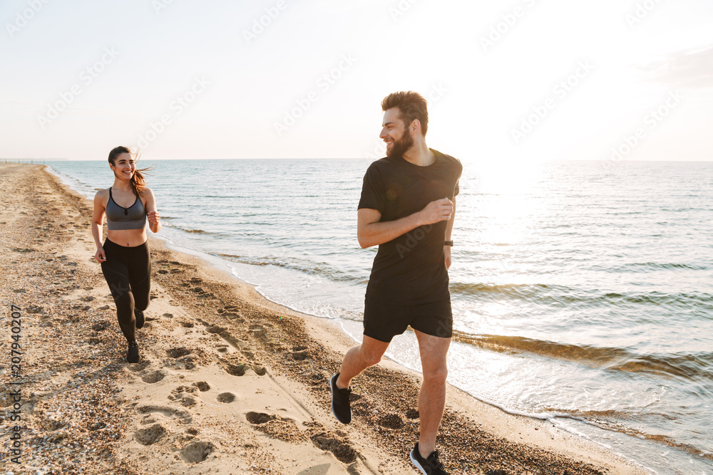 Attractive young couple jogging together