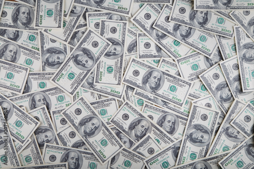 Paper 100 dollar bills spread out on the plane in a chaotic manner Paper 100 dollar bills spread out on the plane in a chaotic manner