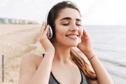 Close up of a pretty young sportswoman in headphones