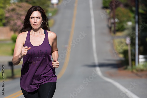 Healthy woman running uphill © Mat Hayward
