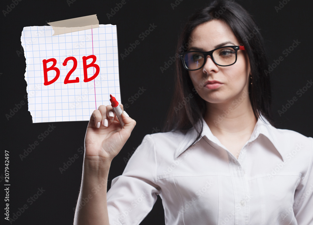 The concept of marketing, technology, the Internet and the network. A young businessman shows what is important for business: B2B The concept of marketing, technology, the Internet and the network. A young businessman shows what is important for business: B2B