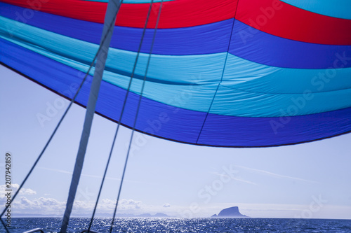 Flying a colorful spinnaker...