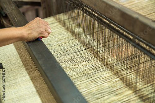 Weaving silk in traditional way in Vietnam. Vietnamese silk processing.