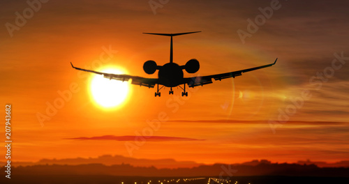 Airplane landing - private jet silhouette on sunset © Skórzewiak