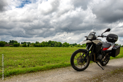 motorcycle on a path with a cloudy sky