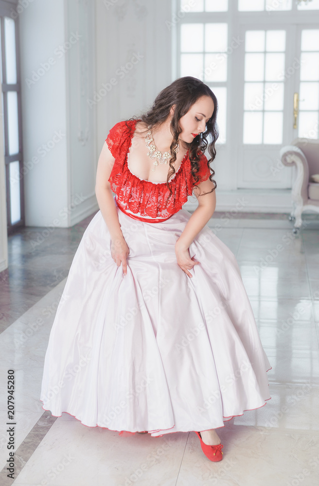 Beautiful woman in medieval dress with crinoline in the hall Beautiful woman in medieval dress with crinoline in the hall