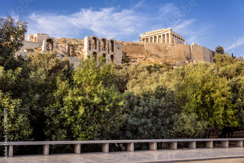 Greece, Athens, Areopagus: People residents toruists visit famous Acropolis with green park trees, horizon and blue clear sky background in the city center of the Greek capital. April 25, 2018