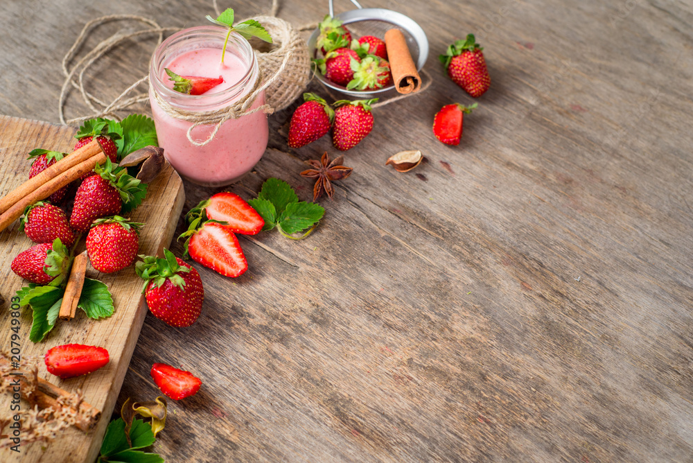 Strawberry smoothies in glass with many strawberries on wooden background. Top view. Copy space Strawberry smoothies in glass with many strawberries on wooden background. Top view. Copy space