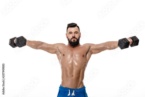 muscular man doing exercises with dumbbells.