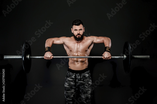 muscular man workout with barbell .