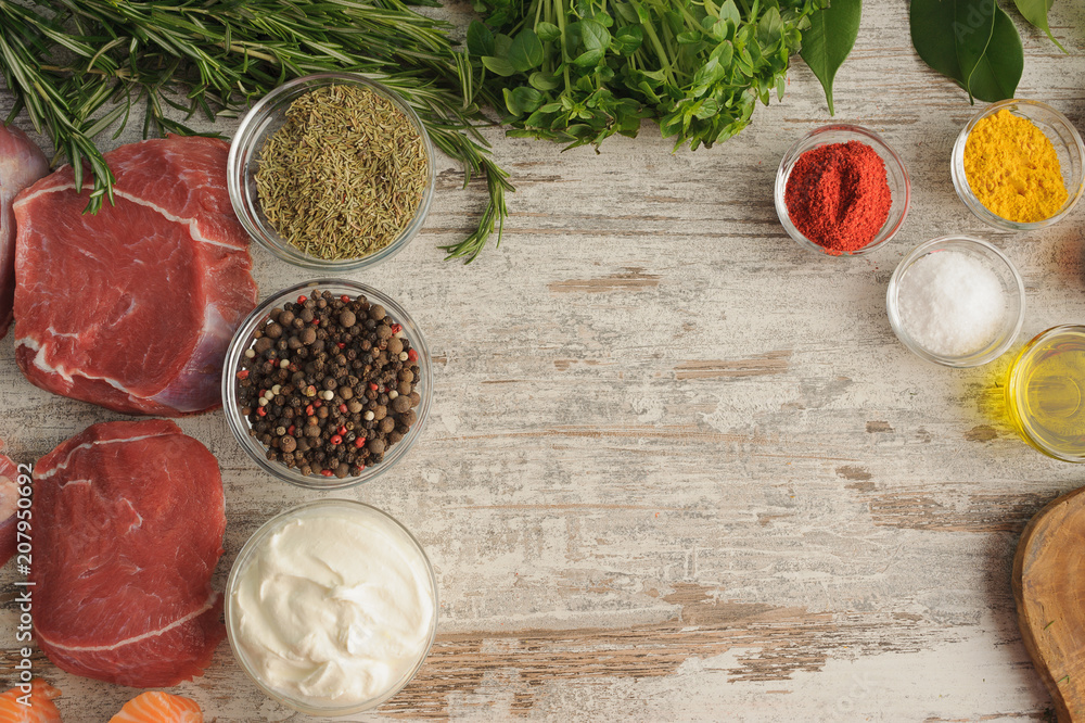 Sous vide. Beef, spice, greens on wooden table top as ingredients for cooking at low temperatures. Sous vide. Beef, spice, greens on wooden table top as ingredients for cooking at low temperatures.