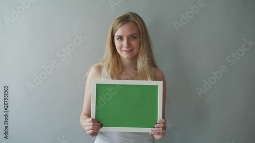 Attractive Woman shows greenkey copyspace with tracking points. photo