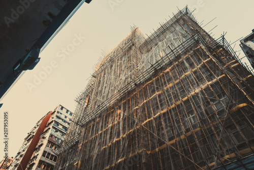 Traditional bamboo scaffolding and shading net setup for paint and instruction building. Asian scaffolding style. photo