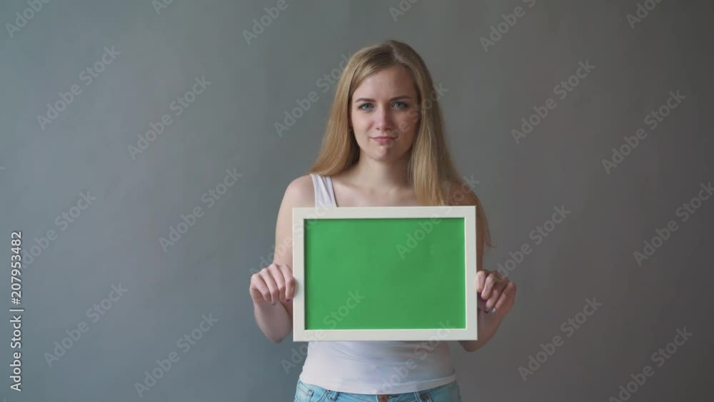 Attractive Woman shows greenkey copyspace with tracking points. Attractive Woman shows greenkey copyspace with tracking points.