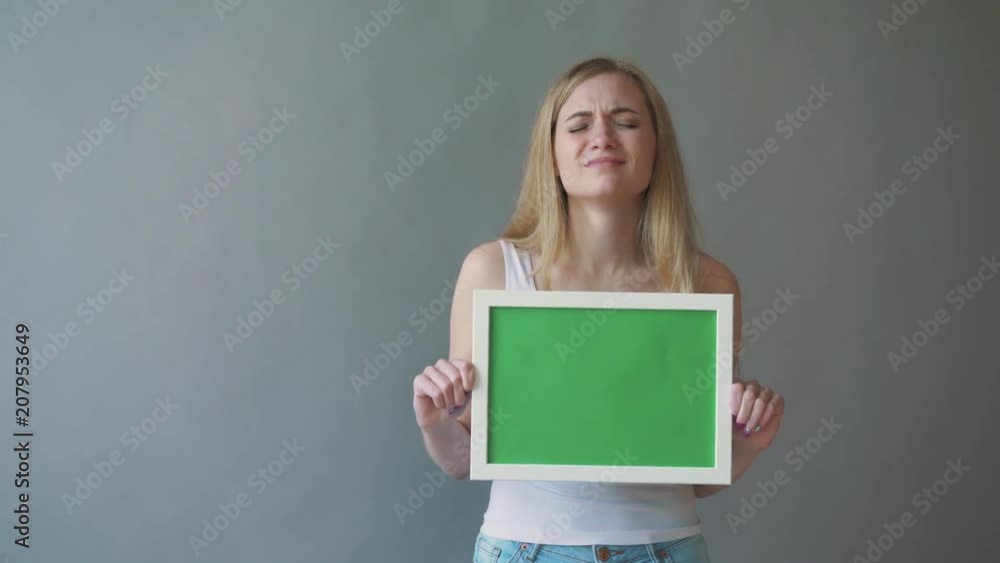 Attractive Woman shows greenkey copyspace with tracking points. Attractive Woman shows greenkey copyspace with tracking points.