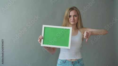 Attractive Woman shows greenkey copyspace with tracking points. photo