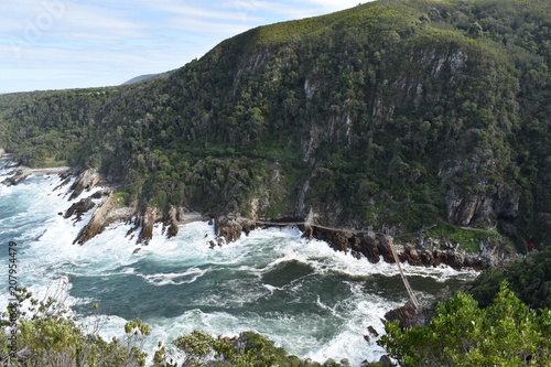 Mountainous Landscape with the beautiful beach and the famous Storms River Bridge at Tsitsikamma National Park in South Africa