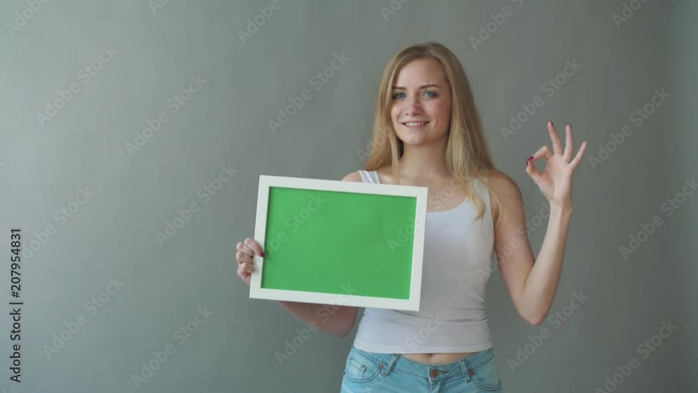 Attractive Woman shows greenkey copyspace with tracking points. Attractive Woman shows greenkey copyspace with tracking points.