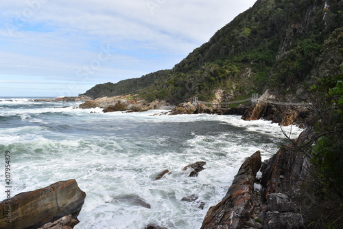 Mountainous Landscape with the beautiful beach and the famous Storms River Bridge at Tsitsikamma National Park in South Africa