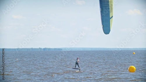 Two kitesurfers flying past each other on kiteboards over the sea
