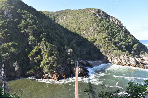 Mountainous Landscape with the beautiful beach and the famous Storms River Bridge at Tsitsikamma National Park in South Africa
