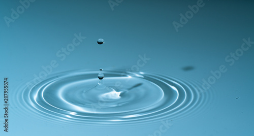 splash drop of water on blue background