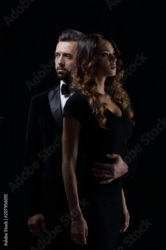 photo of young family couple on black background.