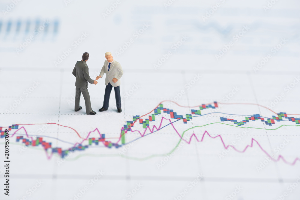 business miniature people on business graph business miniature people on business graph