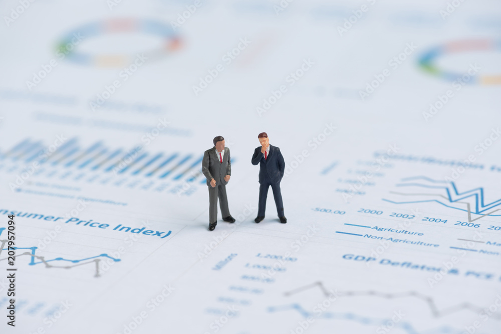 business miniature people on business graph business miniature people on business graph