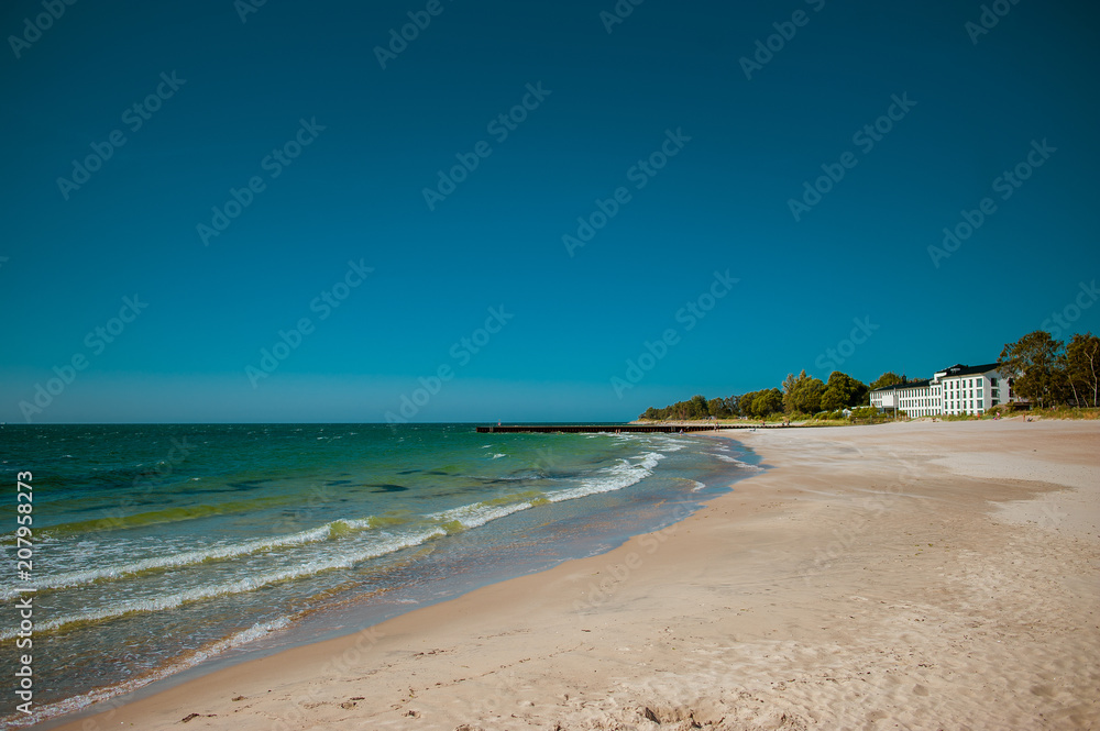 Beautiful sunny beach with white sand at the clear blue Baltic sea in Ystad, Southern Sweden.