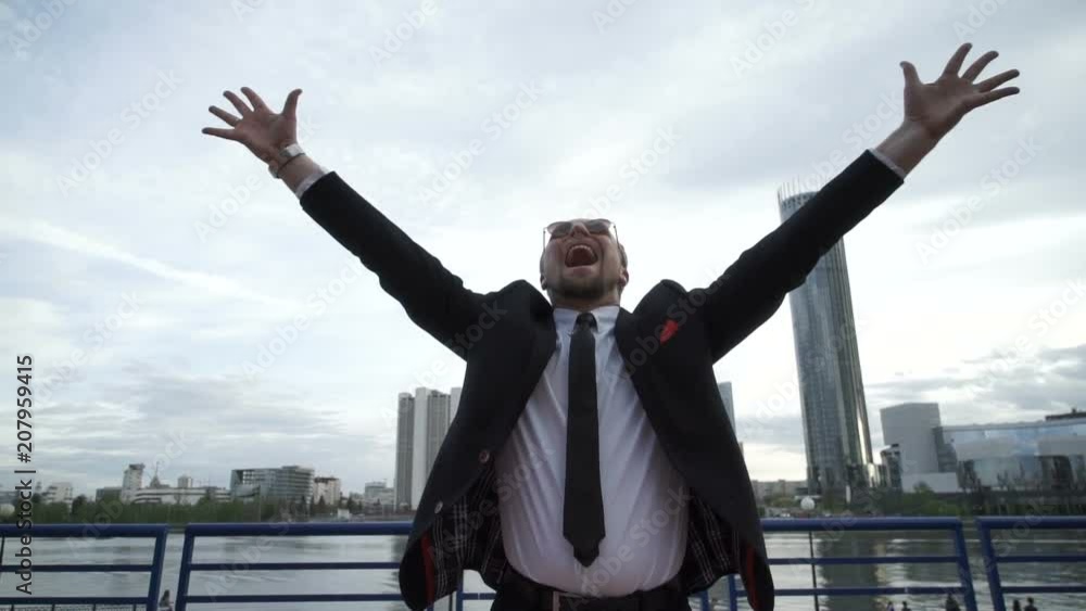 Businessman joyfully screaming in the street Businessman joyfully screaming in the street