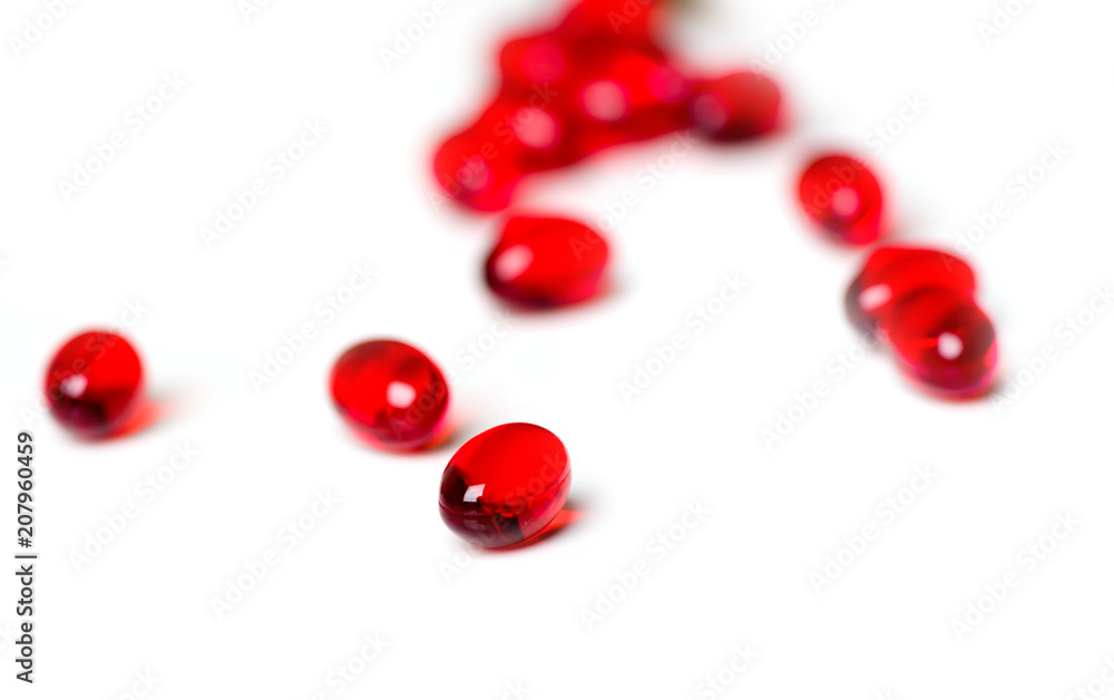 Red capsules with butter and vitamin E on a white background. Care for health. Red capsules with butter and vitamin E on a white background. Care for health.