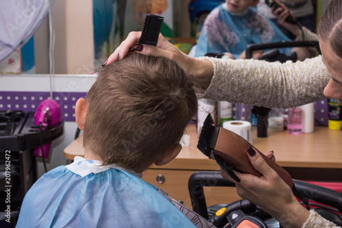 The child is sheared in a children's hairdresser's