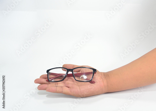 Hand showing black and red eyewear isolated on white background