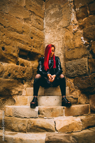 Woman in rebel outfit on stone steps photo