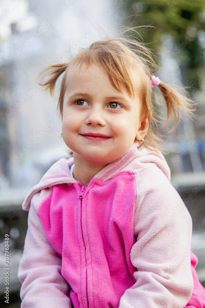 Beautiful little child girl having fun against waterof fountain. Holiday, rest, happiness, summer, childhood concept. Beautiful little child girl having fun against waterof fountain. Holiday, rest, happiness, summer, childhood concept.