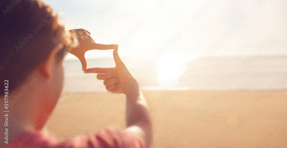 Future planning, Close up of woman hands making frame gesture with sunrise on sea summer, Female capturing the sunrise, sunlight outdoor. - obrazy, fototapety, plakaty 