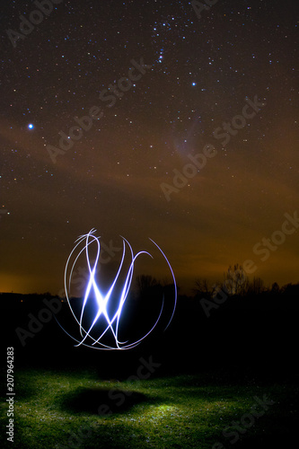 freaky light-art infromt of a very cool looking nightly sky photo