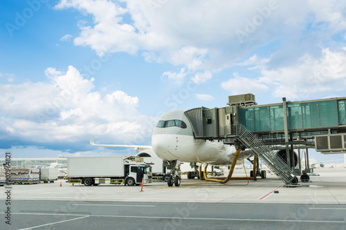 Loading cargo on plane in airport. cargo plane loading for logistic and transport. view through window Passenger terminal