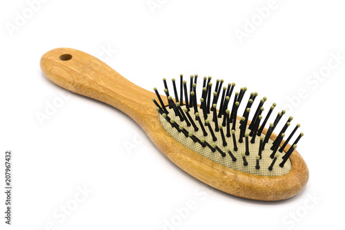 brown wooden hairbrush isolated on white background