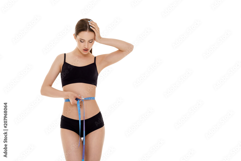 woman measuring waist with blue measuring tape. woman measuring waist with blue measuring tape.