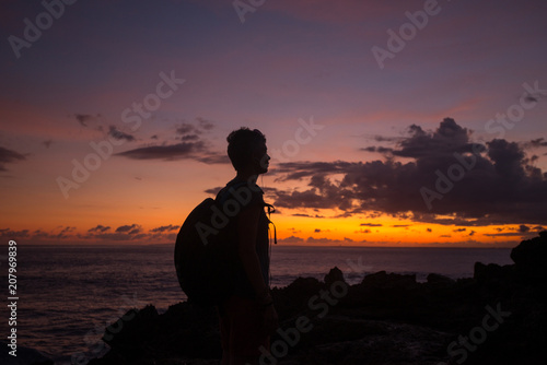silhouette of a girl at sunset near the ocean