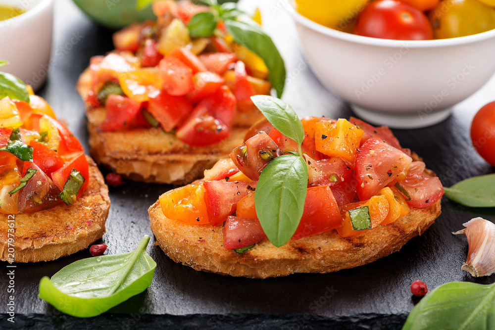 Italian bruschetta with chopped tomatoes and basil on grilled crusty bread. Italian bruschetta with chopped tomatoes and basil on grilled crusty bread.
