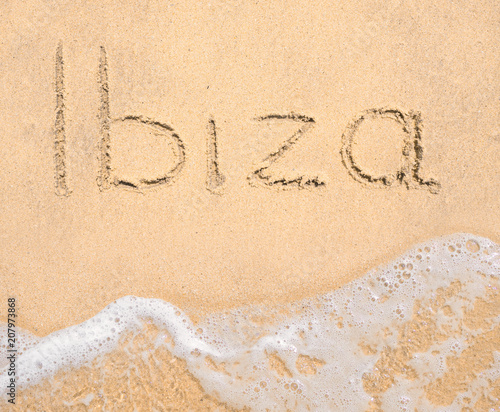 The word Ibiza written in the sand on beach © arttim