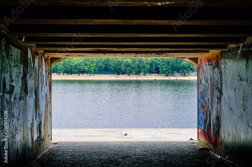 panoramic city landscape, view of the river from the underground passage, the concept of urban objects in nature. Kiev, Ukraine, copy space, closeup. © Nataliia