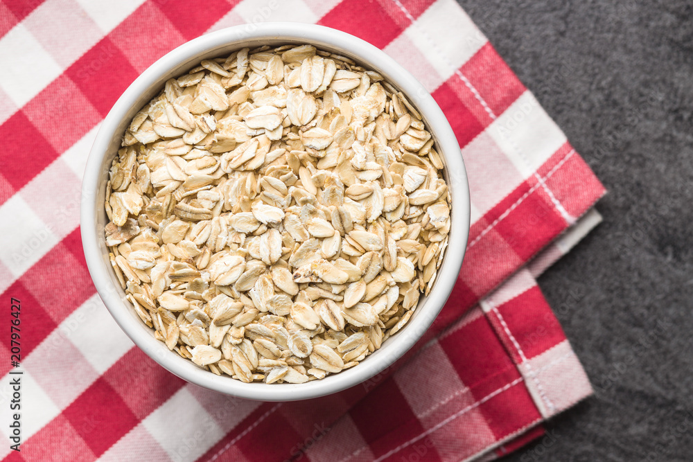 Dry rolled oatmeal in bowl Dry rolled oatmeal in bowl