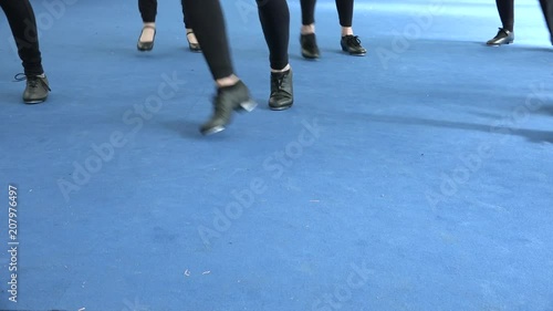 Dance lessons, 50’s lifestyle, tappers school. Jazz style, stage at theatre. Dancer's feet close up. Black tap shoes dancing on blue floor, retro style, vintage music. 
