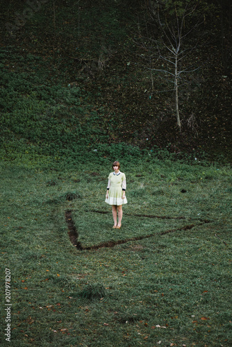 Young woman standing in a triangle photo